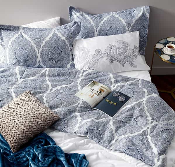 Blue patterned bedding prepared for sleeping
