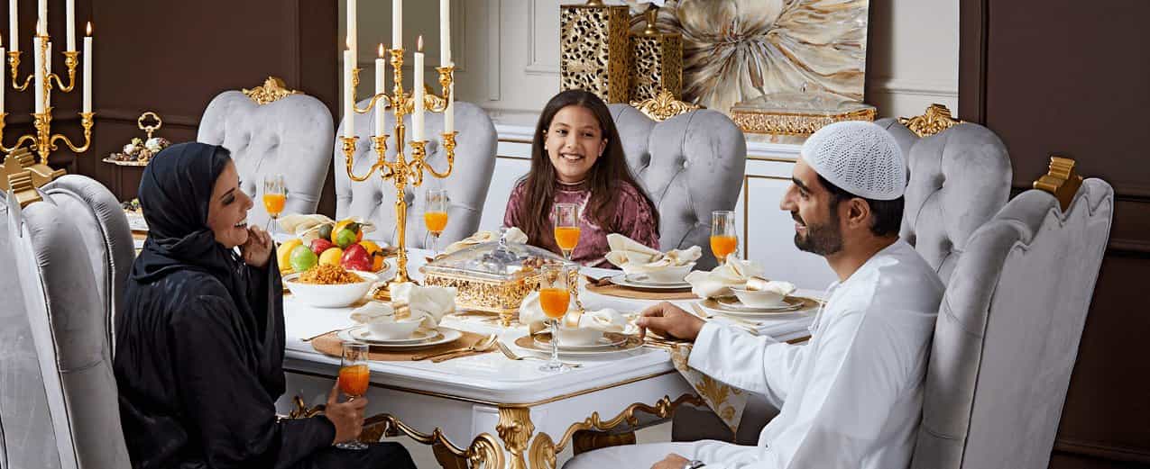 Elegant Arabic family sitting down for a Ramadan dinner.