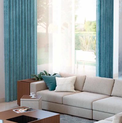 Turquoise blue floor length window curtains matched with minimalist beige sofa 